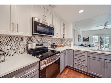 Modern kitchen with stainless steel appliances and gray cabinets at 230 E Ponce De Leon Ave # 219, Decatur, GA 30030