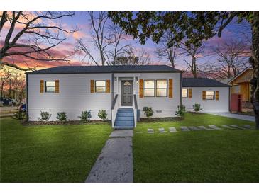 Charming white house with gray roof, wooden shutters, and landscaped lawn at 1092 Donnelly Sw Ave, Atlanta, GA 30310