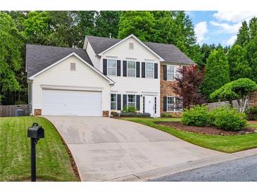 Charming two-story home features a well-maintained lawn and attached two-car garage at 42 Millstone Gln, Dallas, GA 30157