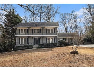 Two-story house with gray siding, black accents, and a manicured lawn at 4825 Kenilworth Dr, Stone Mountain, GA 30083