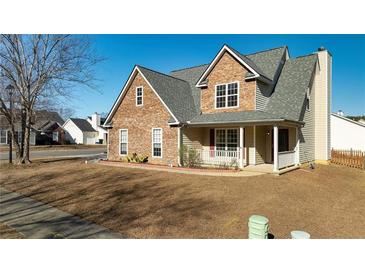 Two-story house with stone and siding accents, front porch, and landscaped yard at 5085 Meadow Trce, Fairburn, GA 30213