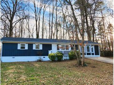 Newly painted blue house with white trim, landscaping, and a long driveway at 212 Valerie Cir, Hiram, GA 30141