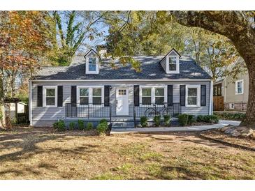 Charming gray house with white trim, landscaping, and a bicycle at 2930 Kimmeridge Dr, Atlanta, GA 30344