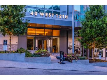 A modern building entrance with the address '40 West 12th' displayed above the doorway at 40 12Th Ne St # 1701, Atlanta, GA 30309