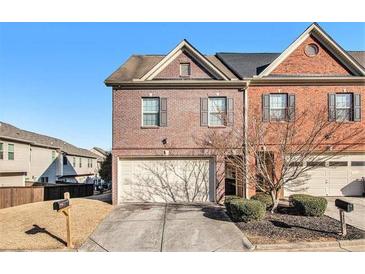 Brick front townhouse with attached garage and landscaping at 7165 Fringe Flower Dr # 5, Austell, GA 30168