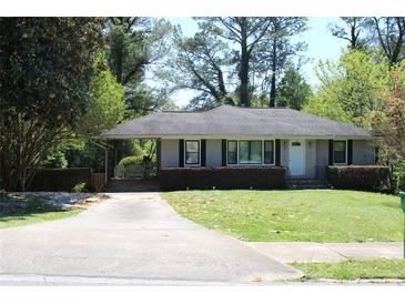 Charming single-story home with a manicured lawn and a convenient carport at 2135 Brannen Se Rd, Atlanta, GA 30316