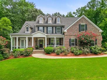 Brick two-story house with front porch and landscaped lawn at 45 Highland Park Way, Sharpsburg, GA 30277