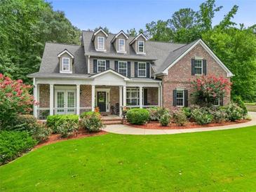 Brick two-story house with large front yard and landscaping at 45 Highland Park Way, Sharpsburg, GA 30277