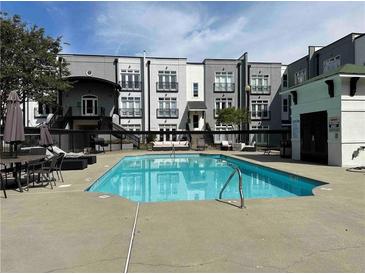 Community pool with surrounding patio furniture at 502 Pryor Sw St # 322, Atlanta, GA 30312