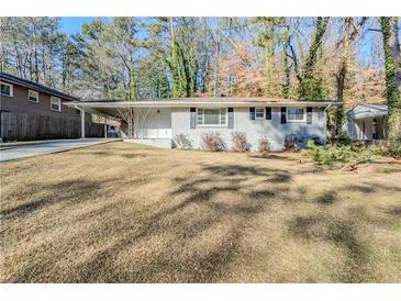 Charming single-story home featuring a well-maintained lawn and a classic brick facade at 3197 Cloverhurst Dr, Atlanta, GA 30344
