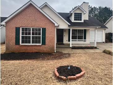 Charming single-story home features brick accents, a dormer window and well-maintained front yard at 3745 Hudson Ct, Rex, GA 30273