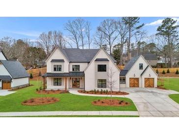 Two-story house with gray roof, white siding, and a two-car garage at 2910 Caney Parc Way, Cumming, GA 30041