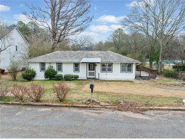 Charming single-story home featuring a classic white exterior and a well-maintained front yard at 1626 Rice Rd, Lithonia, GA 30058