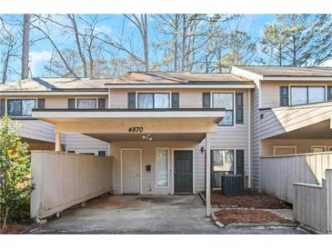 Updated townhome exterior with carport and private fenced yard at 4870 Twin Lakes Trl, Atlanta, GA 30360