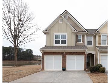 Tan three-story townhome with two-car garage and water view at 1792 Waterside Nw Dr # 10, Kennesaw, GA 30152