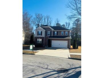 Charming two-story home featuring a wide driveway and attached two-car garage at 1963 White Top Rd. Se, Lawrenceville, GA 30045