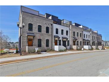 Row of new townhouses with brick and white exteriors at 350 Sugarview Rd, Sugar Hill, GA 30518