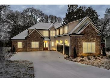 Stunning two-story brick home with a snow-covered front yard at 754 Moon Road, Lawrenceville, GA 30046