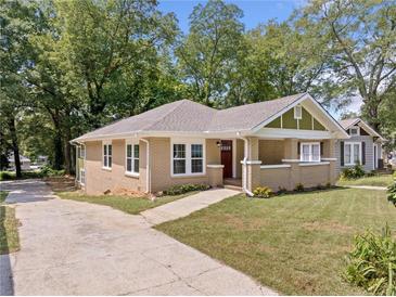 Charming renovated brick home with a covered porch and well-manicured lawn at 1546 Richland Sw Rd, Atlanta, GA 30311