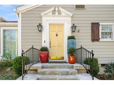 Elegant front door with decorative columns, black lanterns, and stone steps offers welcoming curb appeal at 3495 Habersham Nw Rd, Atlanta, GA 30305