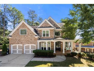 Brick two-story house with a three-car garage and landscaped front yard at 5402 Highland Preserve Dr, Mableton, GA 30126