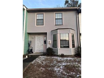 Two-story townhouse with gray siding, a bay window, and a small front yard at 1023 Thornwoode Ln, Stone Mountain, GA 30083