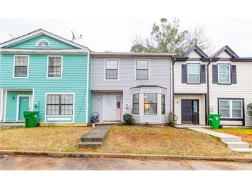 Charming townhomes featuring unique architecture, colorful exteriors and well-maintained yards at 1023 Thornwoode Ln, Stone Mountain, GA 30083