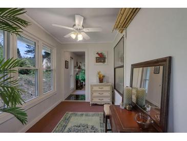 Bright sunroom features large windows, ceiling fan, and decorative furniture at 1414 Branch Dr, Tucker, GA 30084