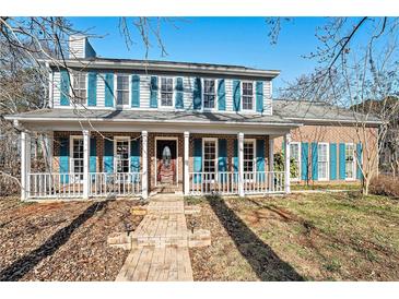 Brick house with blue shutters, a front porch, and a brick walkway at 1491 Laurel River Trl, Lawrenceville, GA 30043