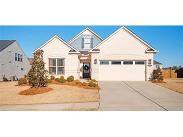 Charming single-story home with a well-manicured lawn and attached two-car garage at 412 Southbridge Pass, Peachtree City, GA 30269