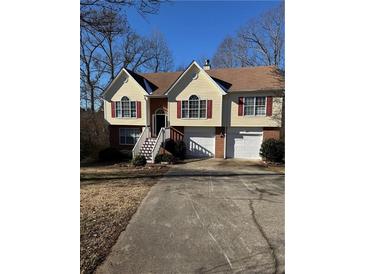 Two-story house with attached garage, manicured lawn, and a charming front entrance at 10561 Aspenwood Ct, Jonesboro, GA 30238