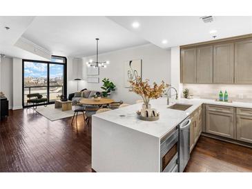 Open-concept living room boasts dark hardwood floors, modern lighting, and expansive city views from a large window at 270 17Th Nw St # 1608, Atlanta, GA 30363