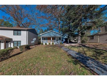 Cute bungalow with front porch, nicely landscaped yard, and walkway at 1333 Womack Ave, Atlanta, GA 30344