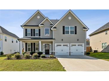 Two-story house with gray siding, white trim, and a three-car garage at 13136 Vista Ln, Covington, GA 30014