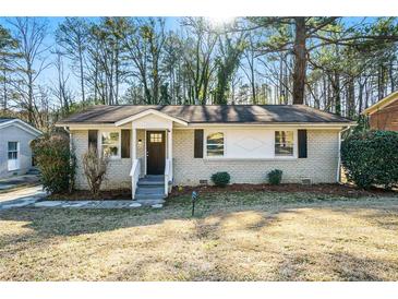Ranch style home with brick facade, front door, and landscaped yard at 3218 Ward Sw Dr, Atlanta, GA 30354