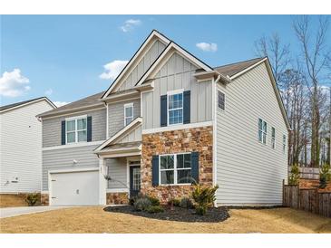 Charming two-story home featuring stone accents, gray siding, and a well-manicured lawn at 251 Ivy Chase Loop, Dallas, GA 30157