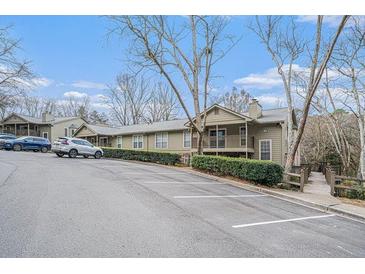 View of complex with ample parking and mature landscaping on a sunny day at 2901 Lenox Ne Rd # 506, Atlanta, GA 30324