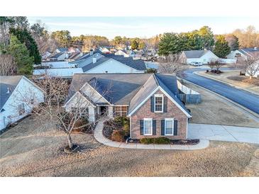 Charming brick home featuring a well-manicured lawn and a curved walkway in a desirable neighborhood at 2650 Hamilton Chase Run, Buford, GA 30519