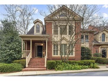 Brick front exterior of charming two-story home with manicured landscaping at 1000 Riverside Rd, Roswell, GA 30076