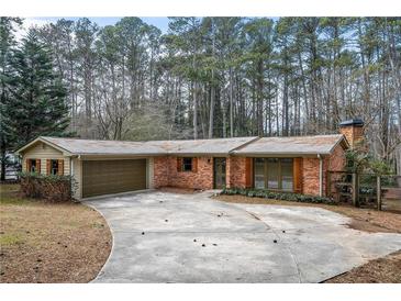 Charming brick ranch home with attached garage and mature trees in a quiet neighborhood at 2468 Ridgeway Dr, Atlanta, GA 30360