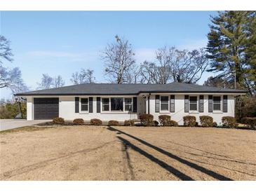 Ranch style home with white brick, black shutters, and a two-car garage at 2488 Elizabeth Ann Ne Ln, Atlanta, GA 30324