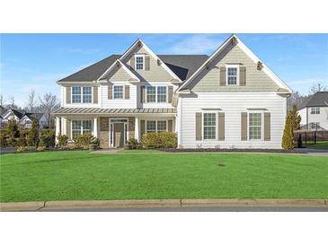 Two-story house with white siding, gray accents, and a lush green lawn at 6850 Canyon Creek Way, Cumming, GA 30028