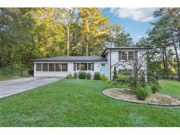 Ranch style home with white exterior, landscaping, and a spacious lawn at 785 Mckenzie Sw Ct, Atlanta, GA 30311