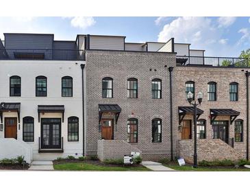 Three-unit townhome development showcasing modern brick exteriors and rooftop decks at 332 Sugarview Rd # 16, Sugar Hill, GA 30518