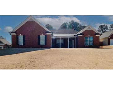 Brick home with covered porch and large windows at 2105 Rock Ct, Loganville, GA 30052