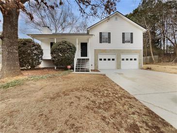 Inviting white house with a two-car garage and a front porch at 108 Ridgefield Dr, Douglasville, GA 30134