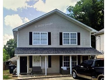 Two-story duplex with covered porches and a spacious yard at 151 Roy St # A & B, Canton, GA 30114