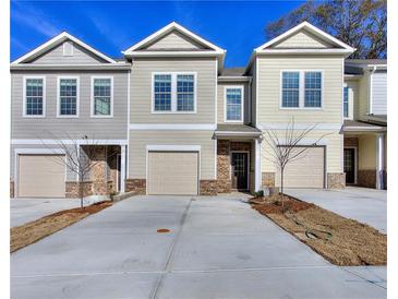 Two-story townhome with neutral siding and attached garage at 6166 Ripple Way # 79, South Fulton, GA 30349