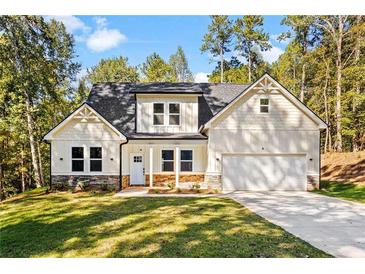 Craftsman style home with light beige siding, stone accents, and a two-car garage at 485 N Oakland Circle, Mcdonough, GA 30253