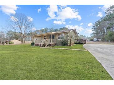 Ranch style home with large yard and paved driveway at 400 Fleeta Dr, Covington, GA 30016